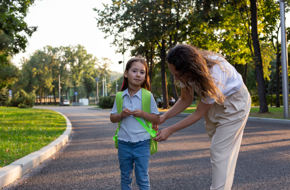 A mother helping her daughter prepare for the school day