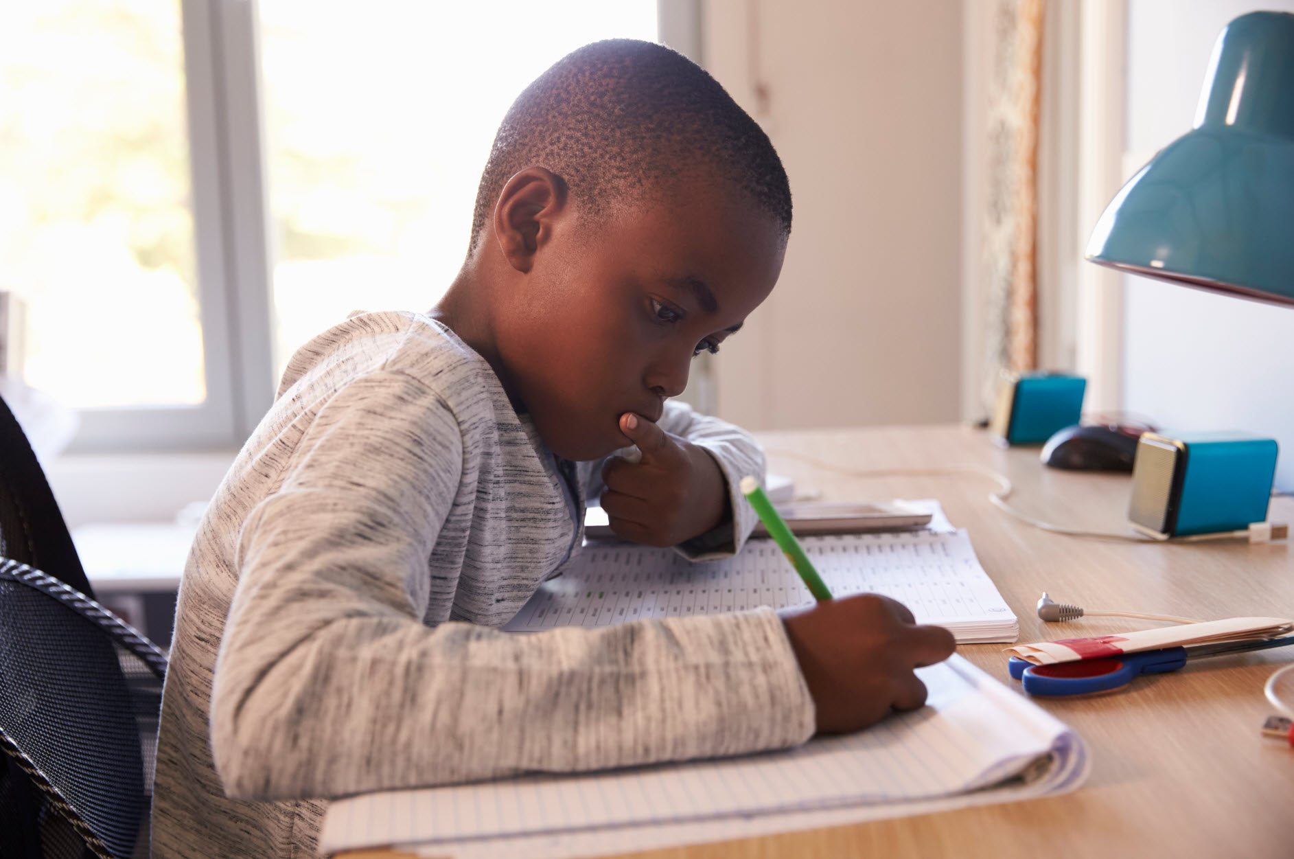 A child completing schoolwork at a table